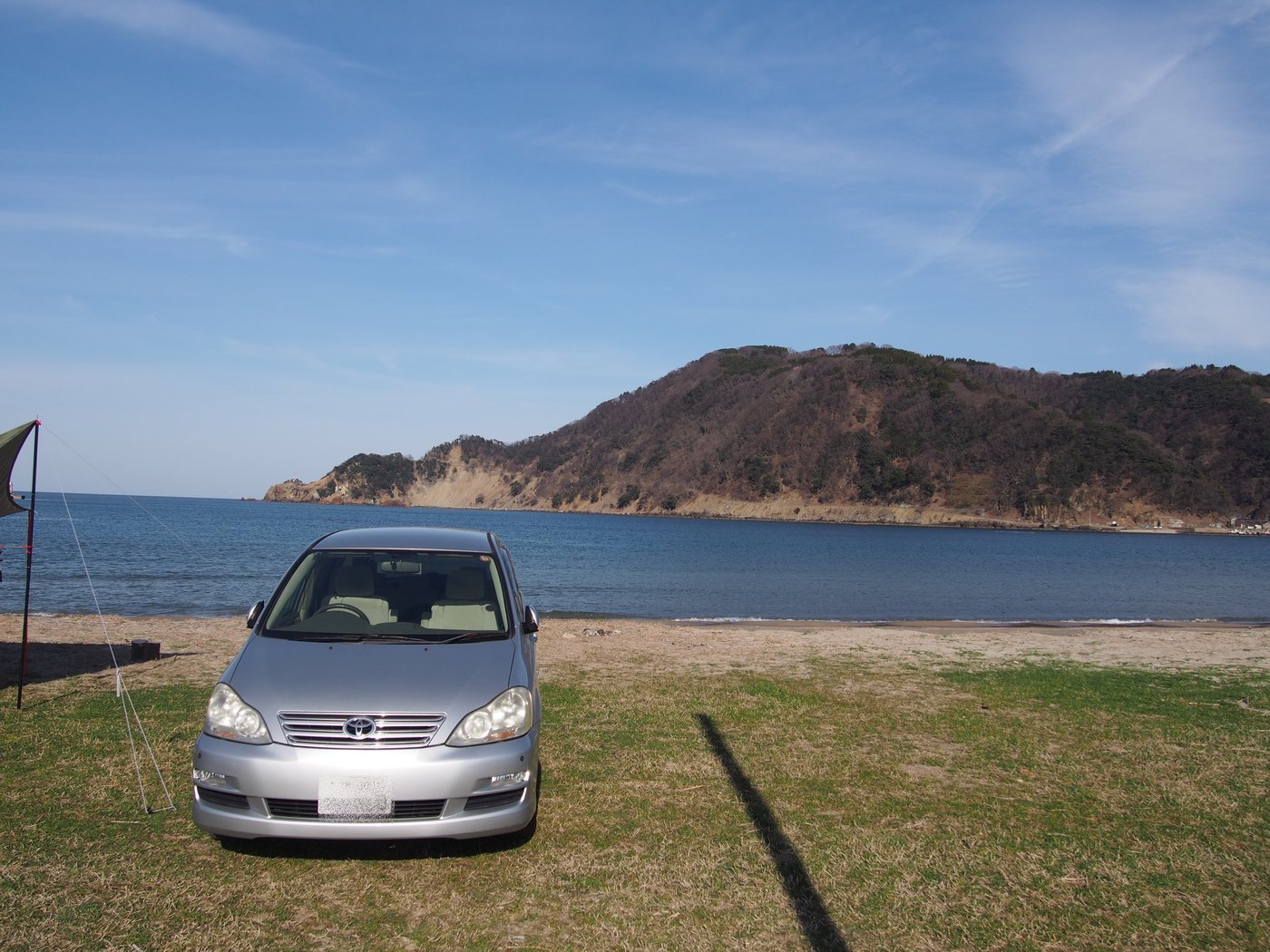 2019年3月9日、気比の浜キャンプ場のサイトに停めた車と砂浜と海
